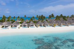Holiday villas line the beach in the tropical Maldives