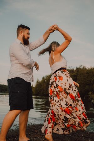 Loving couple standing ankle deep in water on beach