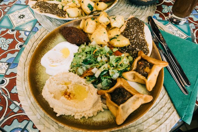 Plate with delicious food on table