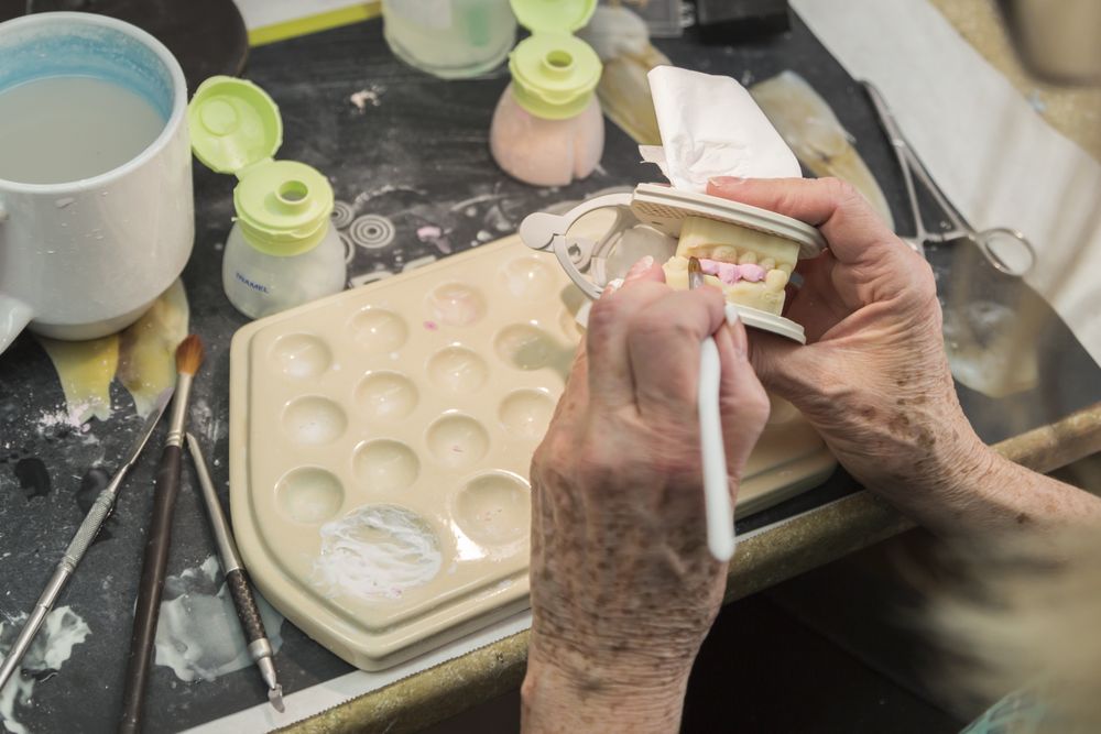 Dental Technician Applying Porcelain To 3D Printed Implant Mold