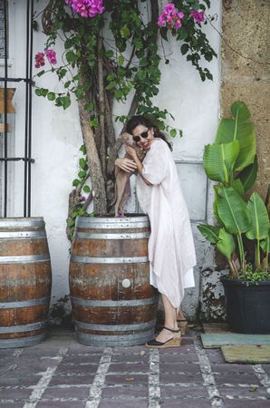 Happy female embracing cute dog outside