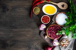Top view of wooden table with the ingredients for vegetarian chili with copy space