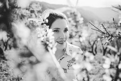 Young happy woman between trees in garden