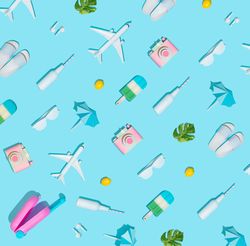 Suitcase and beach items, like camera, sunglasses, flip flops, on pastel blue background
