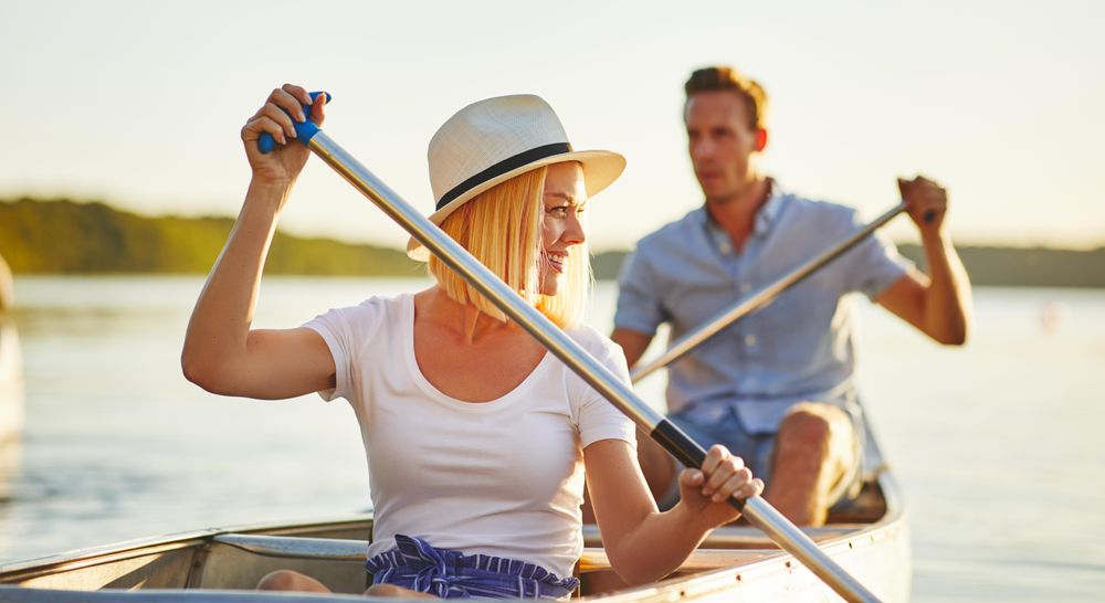 Two people canoeing on a bright summer day