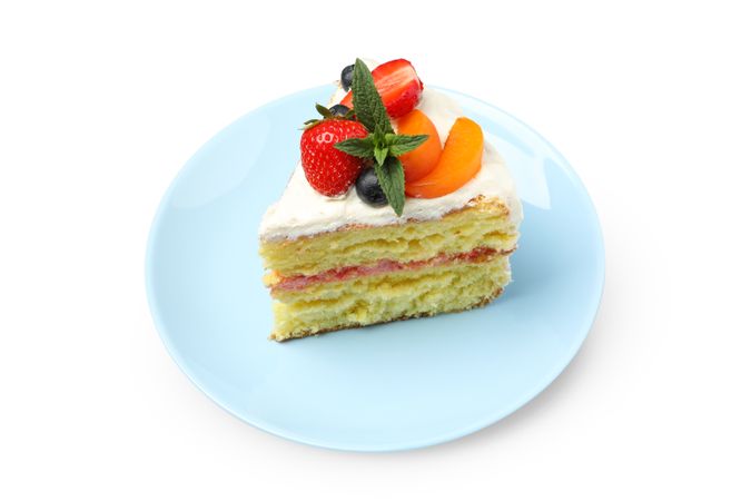 Plate with berry cream cake isolated on plain background