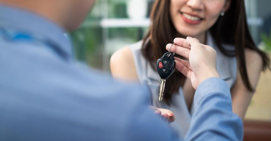 Female receiving car keys from male