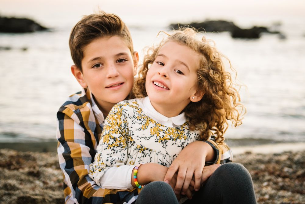 Cute boy and girl hugging each other at beach