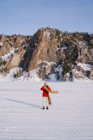 Woman enjoying winter day in snowy valley