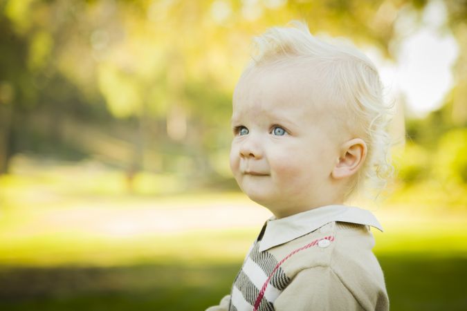 Adorable Blonde Baby Boy Outdoors at the Park.