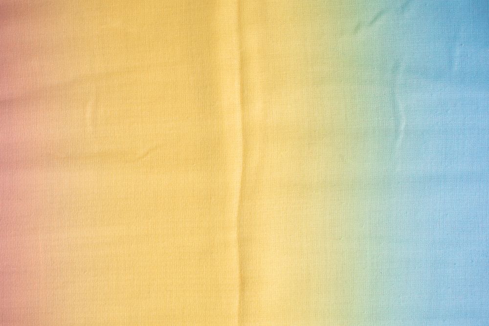 Gradient yellow blue pink and green fabric  background texture.
