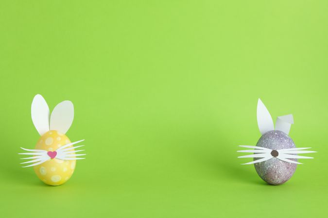 Decorated Easter eggs and cute bunny's ears on color background. Space for text