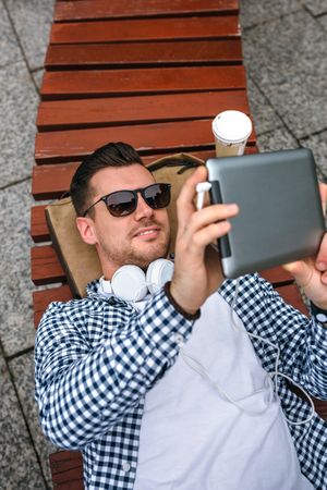 Young man using tablet outdoors