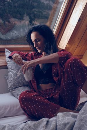 Serene woman chilling in bedroom in cottage
