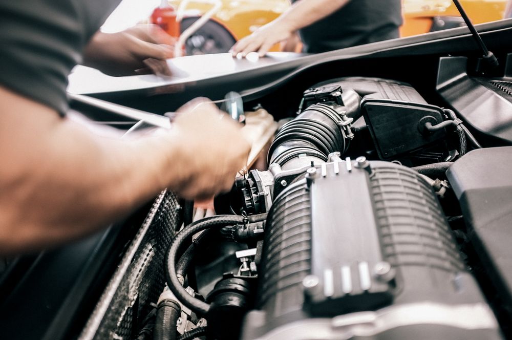 Close up shot of the hands of mechanics working on a vehicle