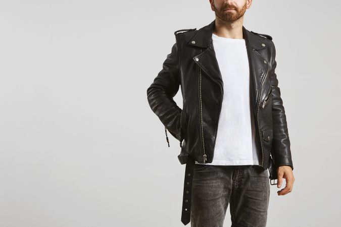 Man in dark leather biker jacket and light t-shirt