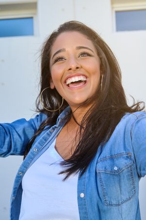 Cheerful young woman smiling and looking away