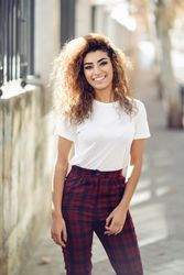 Portrait of smiling Arab woman standing outside