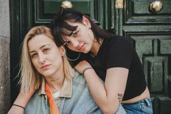 Lesbian couple sitting near door