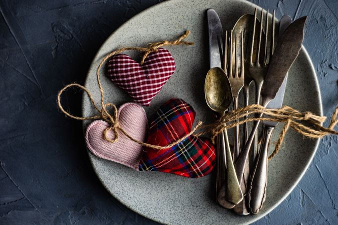 St. Valentine day table setting with felt hearts and cutlery