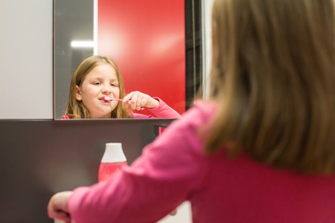 Cute girl brushing her teeth