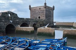 Blue boats moored at old building