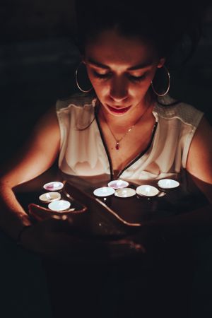 Woman swimming in pool with candles