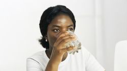 Black Woman in Her 20s Drinking a Healthy Juice.