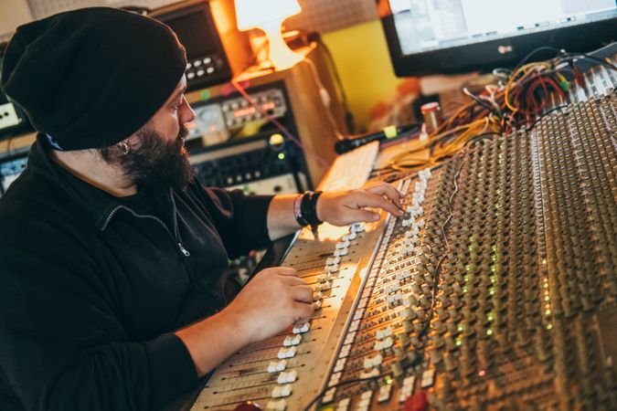 Man in a equalizer instrument in a studio