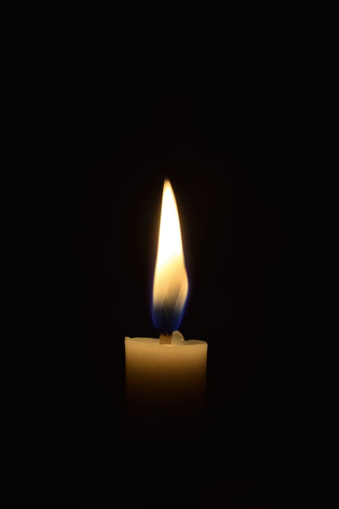 Side view of candle flame in the dark