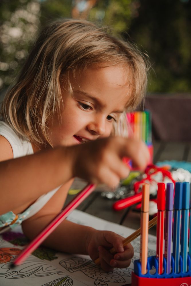 Girl coloring pictures at home