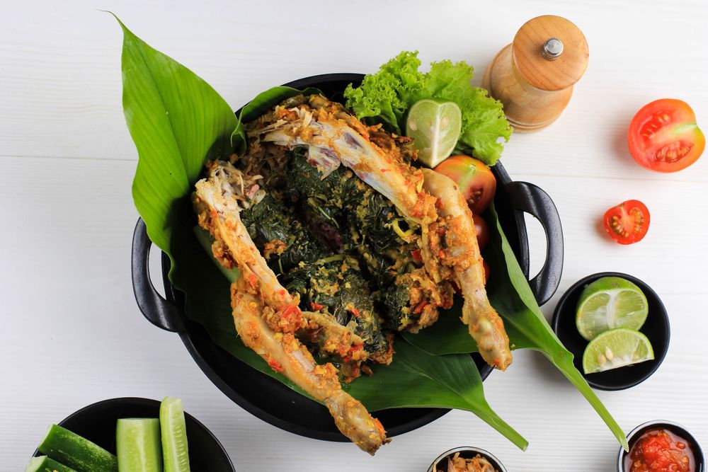 Ayam Betutu, Balinese Roast Chicken Stuffed with Cassava Leaves.