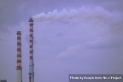 Two factory chimneys emitting industrial smoke 42Eqm5