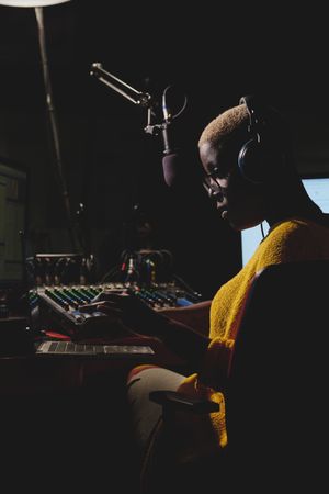 Serious Black woman working at radio station