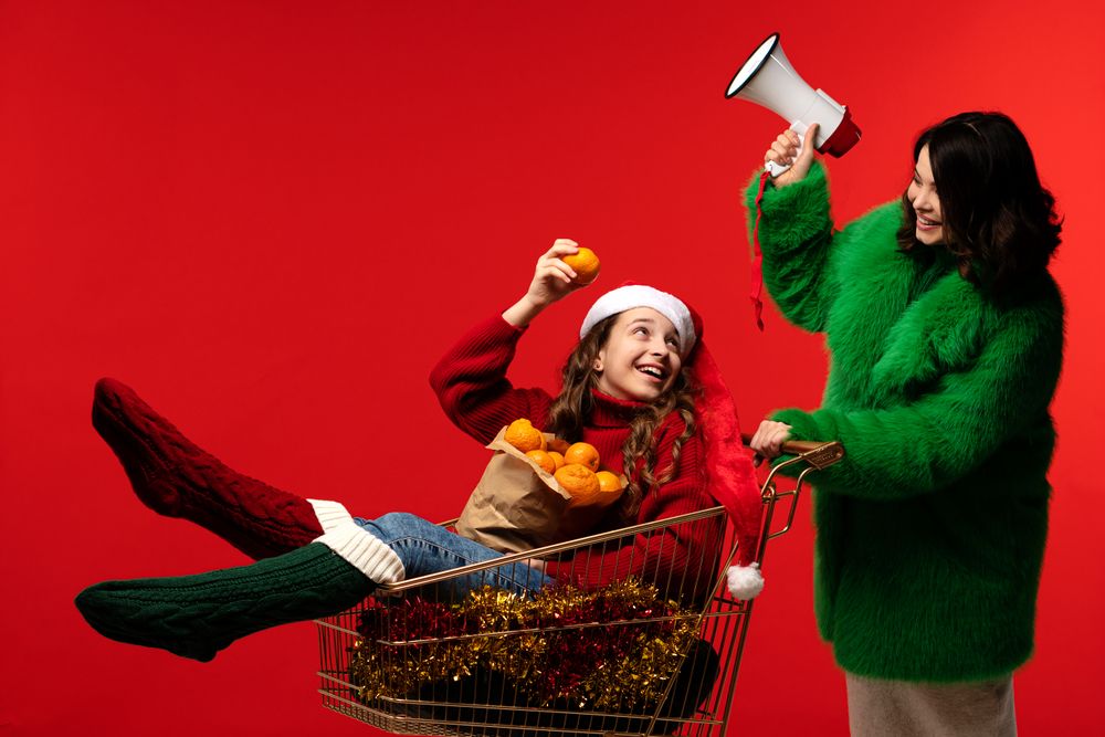 Mum uses megaphone while teenage daughter holds oranges in cart