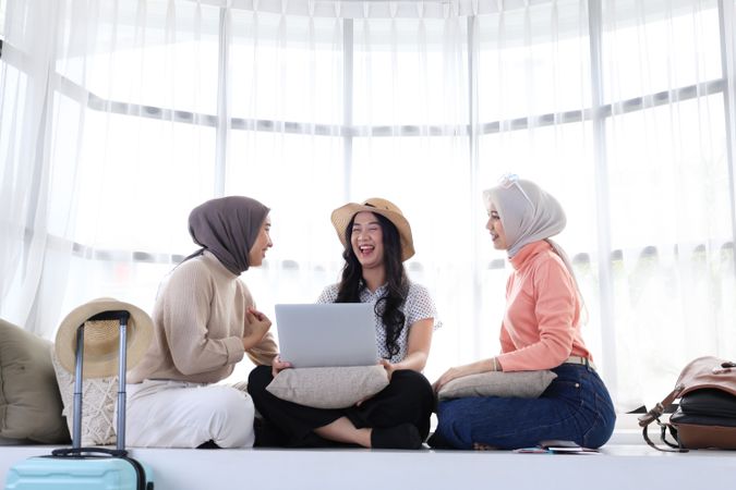 Three Asian Woman Friend Sitting at Home Preparing Itinerary using Laptop