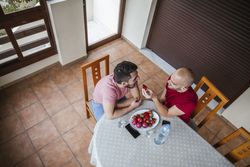 Gay couple eating strawberries