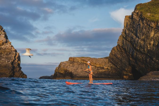 Woman on paddleboard floating in sea