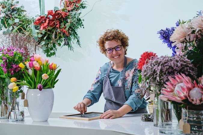 Happy woman working in floral shop