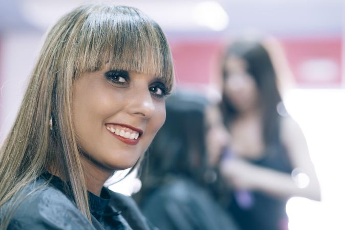 Smiling hair stylist with bangs