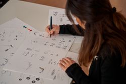 Woman making sketches of jewelry accessories