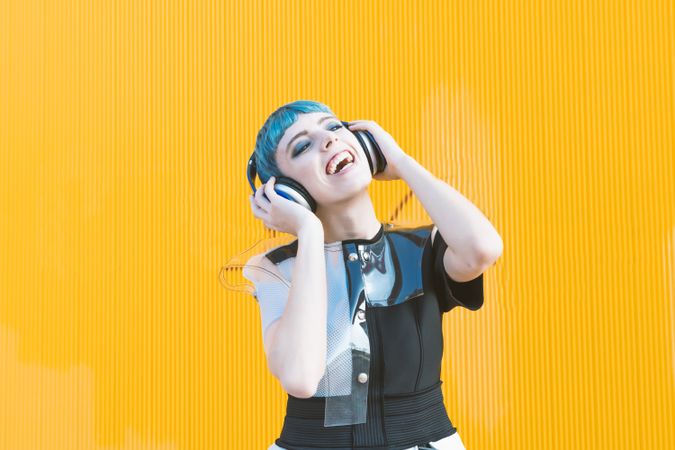 Cool informal woman in headphones on street
