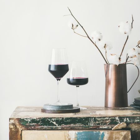 Wine glasses with dried cotton in vase, square crop, copy space