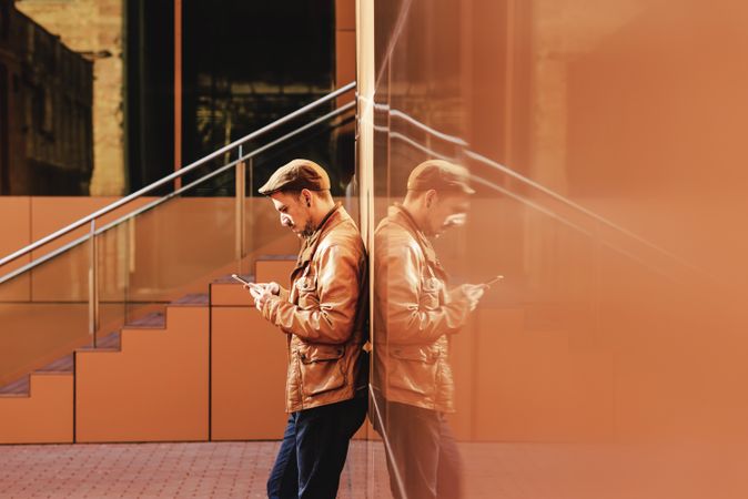 Man using mobile phone in modern building