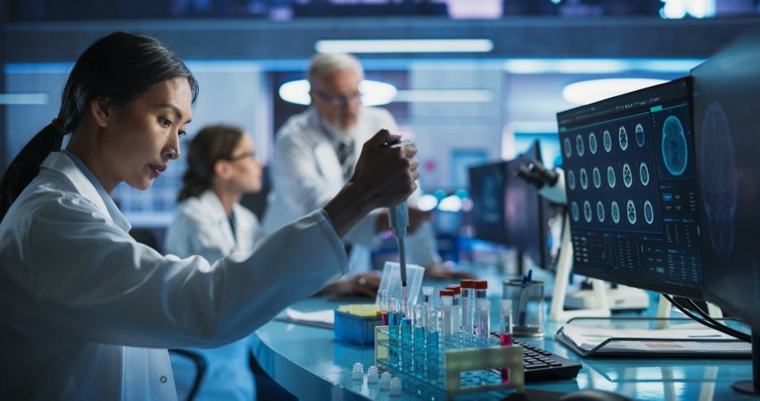 Biotechnology Research Laboratory: Female Asian Doctor Working With Test Tubes To Study Effect Of Innovative Alzheimer's Medicine.