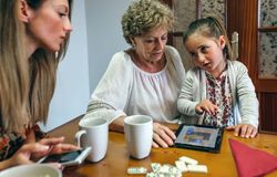 Little girl asking permission to continue playing tablet