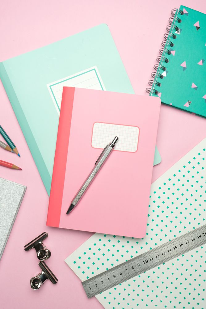 School stationery set on pink background