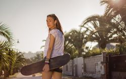 Young girl with a skateboard outdoor