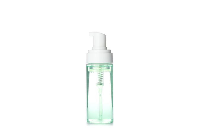 Liquid in spray bottle isolated on plain background