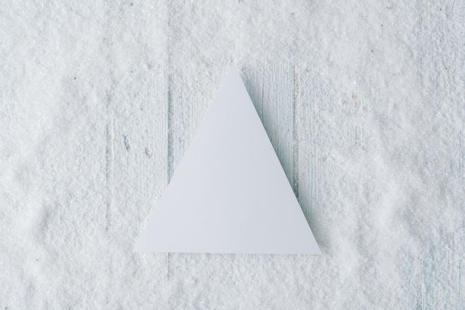 Wooden table background with snow and festive tree decoration